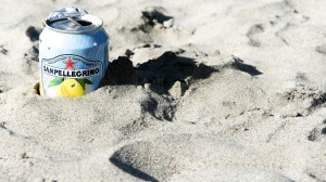San Pellegrino soda can in the sand, California